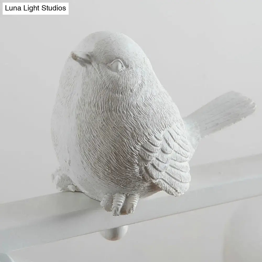 A white textured bird figurine with detailed feathers perched on a metal rod for dining room clear glass decor
