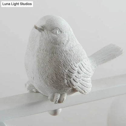A white textured bird figurine with detailed feathers perched on a metal rod for dining room clear glass decor