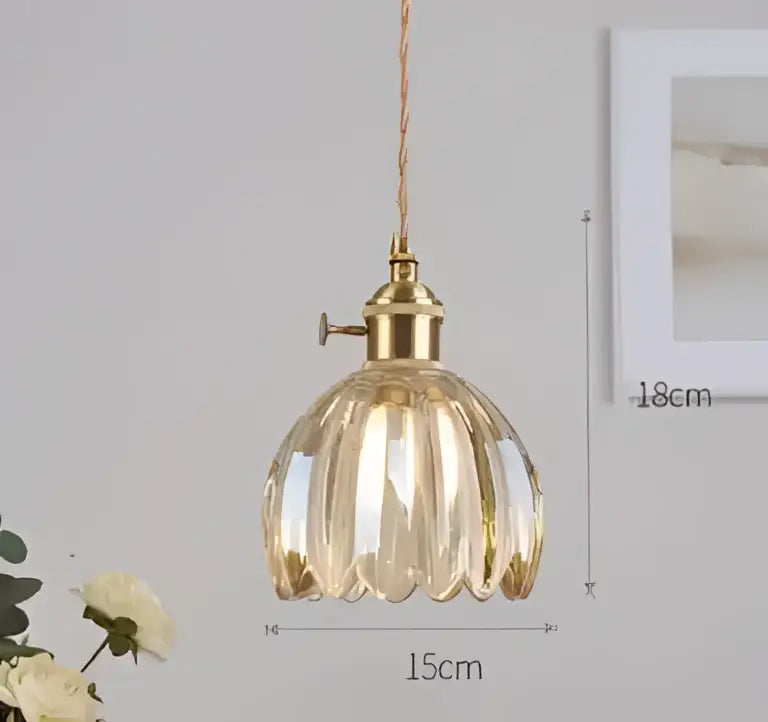 A golden faceted glass pendant light with brass fixture and twisted cord complementing decorbites blue glass pendant lights