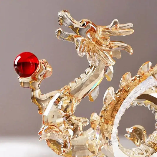 Translucent golden crystal dragon statue holding a red orb for feng shui living room decor by decorbites