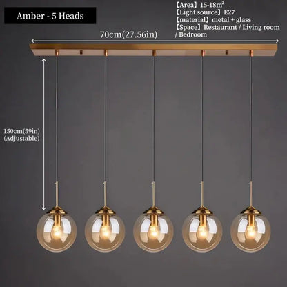 Modern amber glass pendant light with five spherical bulbs and polished steel brass-finished metal fixtures for dining room