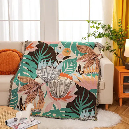Cozy knit throw blanket with vibrant tropical floral pattern in teal pink and cream for decorbites cozy knit decor