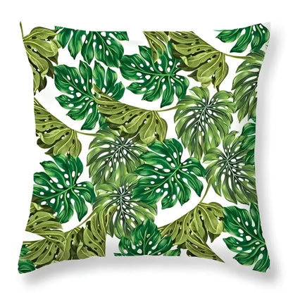 A square throw pillow with vibrant green leaves decorative pattern on white background for living room home decor