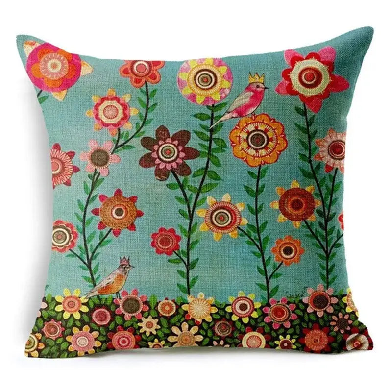 Teal linen throw pillow with vibrant pink orange and yellow floral pattern and crowned birds for green leaves decorative home decor
