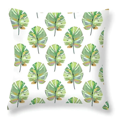 White throw pillow with repeating watercolor pattern of green leaves decorative for tropical home decor