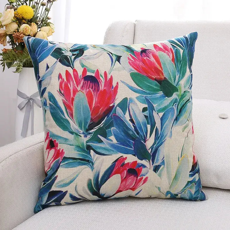 Vibrant floral cushion cover with bold pink protea and green plant leaves on beige linen for living room decorbites decor