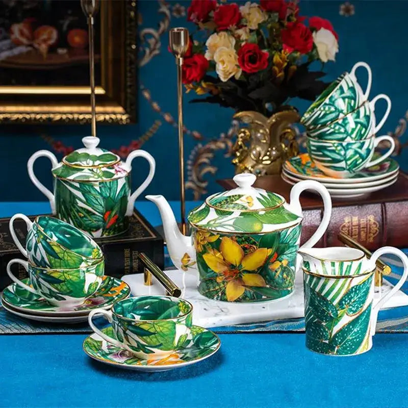 A vibrant green leaf collection porcelain tea set with yellow tropical leaves and gold-trimmed handles for dining room use