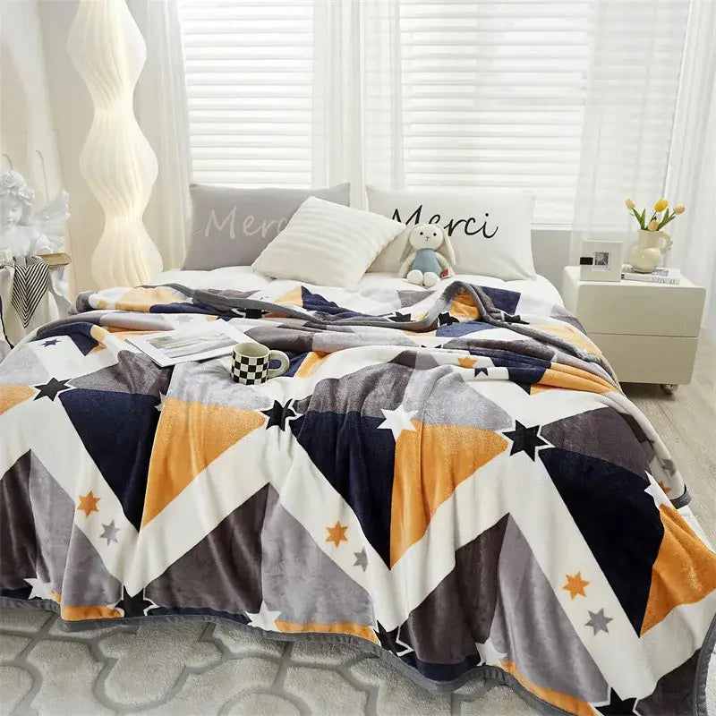 Decorbites cozy flannel blanket featuring a geometric navy blue orange gray and white pattern with star motifs