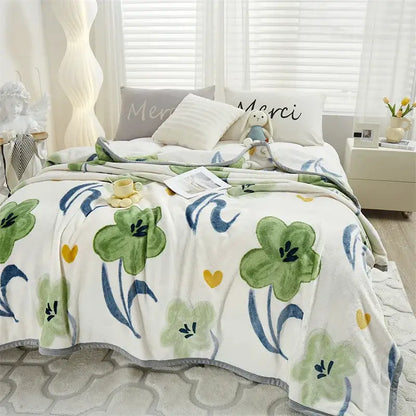 Tropical leaf light blue cozy flannel blanket with white plush textured surface and green blue floral decorbites cozy flannel