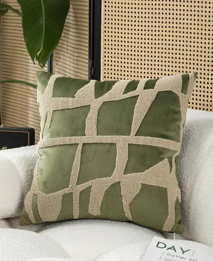 Olive green velvet throw pillow with cream geometric embroidery in embroidered patchwork cushion cover design