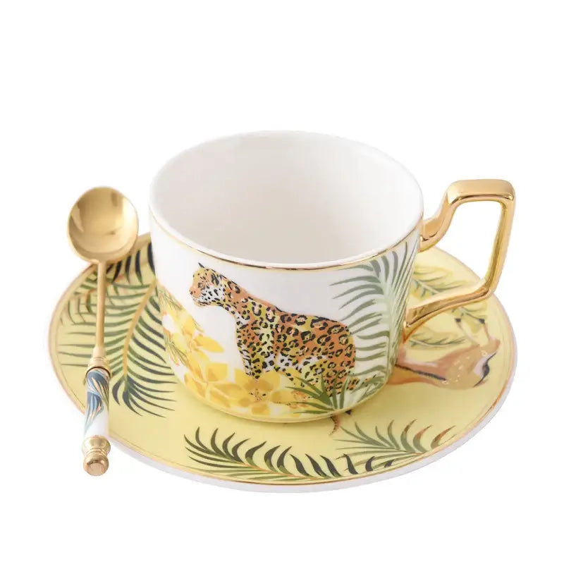 White ceramic tea cup with gold rim and leopard illustration from tropical pink and black toucan porcelain tea cup set