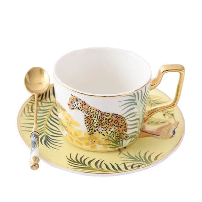 White ceramic tea cup with gold rim and leopard illustration from tropical pink and black toucan porcelain tea cup set
