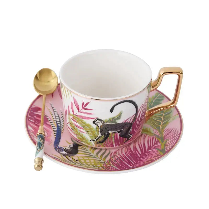 Pink ceramic tea cup set with gold trim and black monkey illustration in tropical pink and black toucan porcelain design