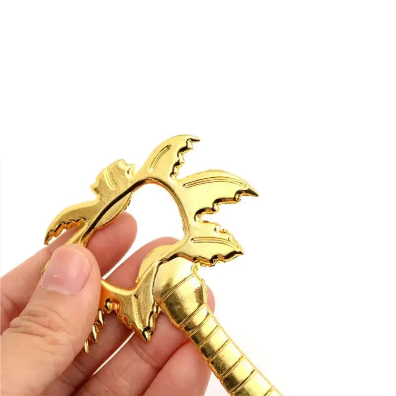 Gold-colored metallic dragon-shaped bottle opener with detailed wings and segmented tail for decorbites coconut tree bottle use