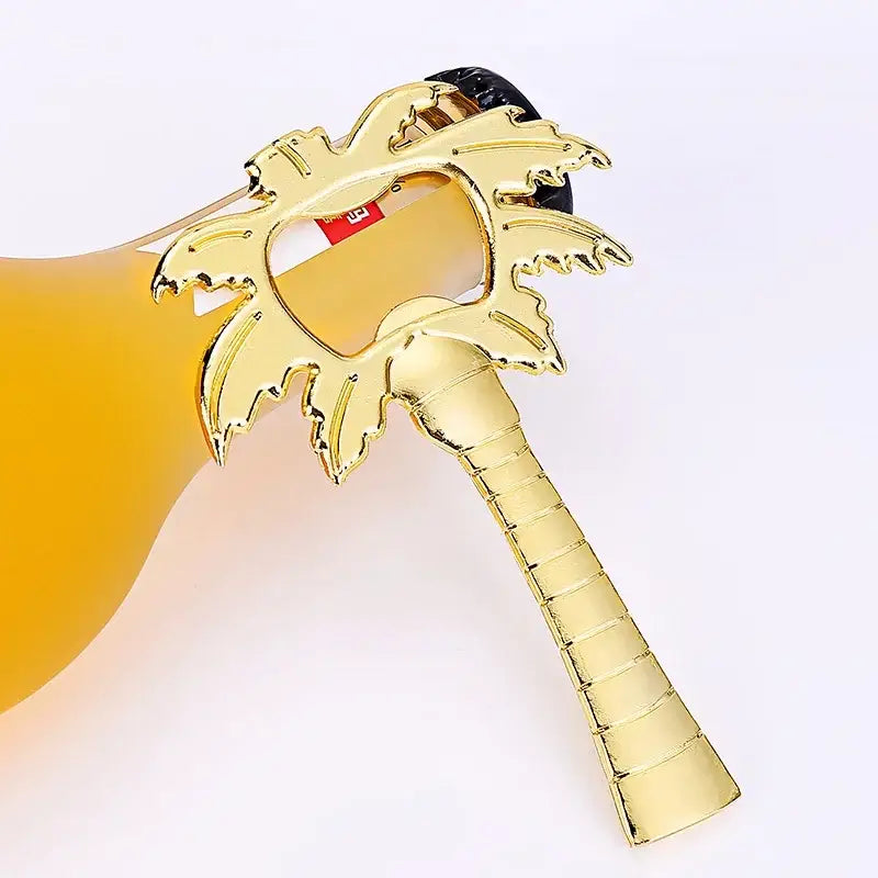 Golden palm tree-shaped metal decorbites coconut tree bottle opener with textured trunk and leaf design for kitchen use