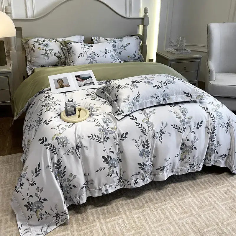 White satin-like duvet cover with gray and green floral pattern and ruffled edges in decorbites ice silk plant bedding set