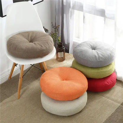 Round tufted grey linen floor pillow seating cushion with soft fabric in earthy tones for living room pouf use