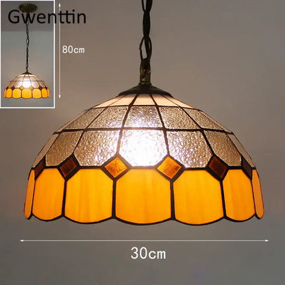 A warm-toned hexagonal pendant light with amber and frosted glass panels featuring diamond square stained design