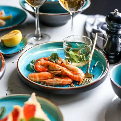 Vibrant turquoise ice cracking glaze ceramic tableware set featuring shrimp on a plate with fresh herbs and infused water