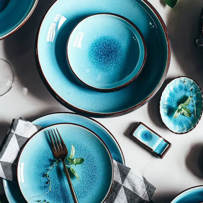 Set of blue ceramic tableware set with ice cracking glaze and dark brown rims for dining room use