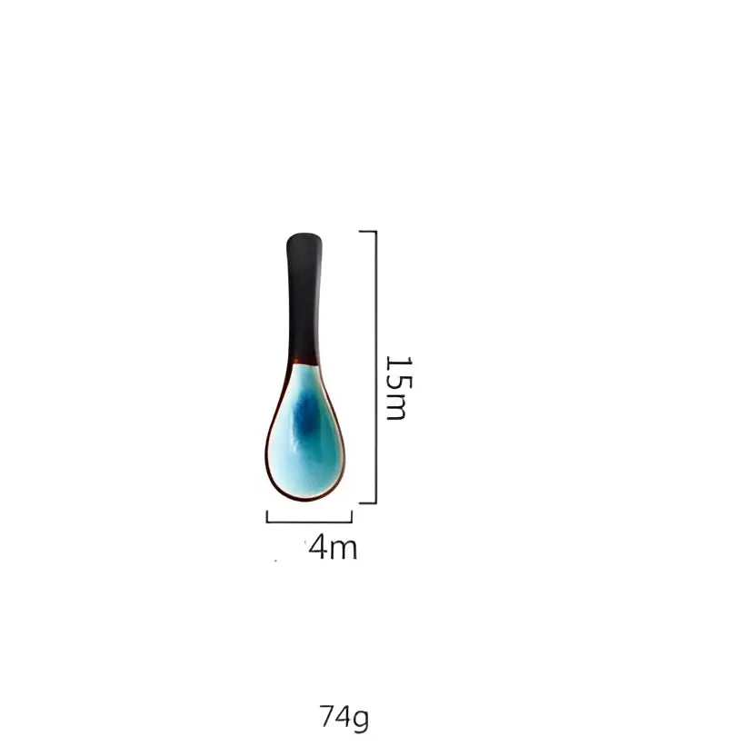 A sleek 15cm ceramic spoon with glossy black handle and turquoise blue bowl from ice cracking glaze tableware set