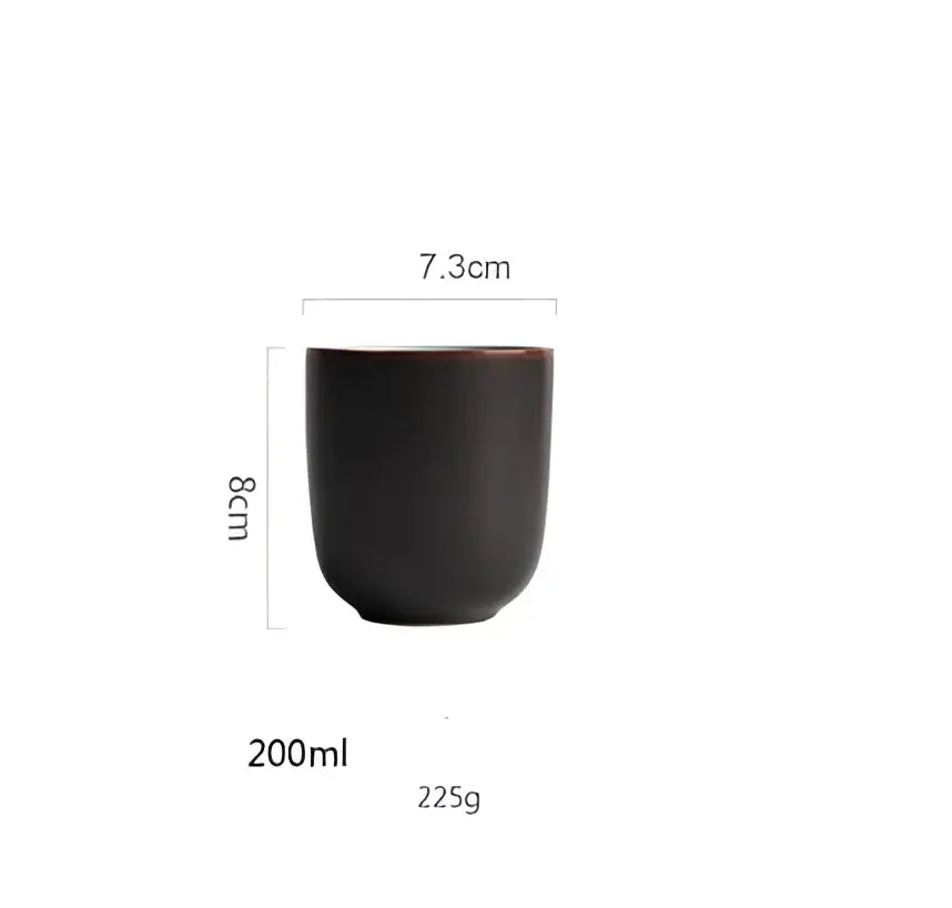 A sleek matte black ceramic mug with rounded body and flared rim from turquoise ice cracking glaze ceramic tableware set
