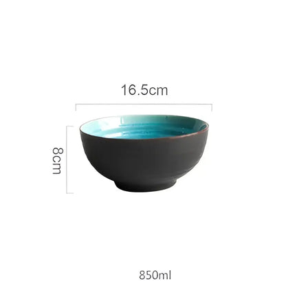 A sleek ceramic tableware set bowl with matte black exterior and turquoise ice cracking glaze interior measuring 16.5cm diameter
