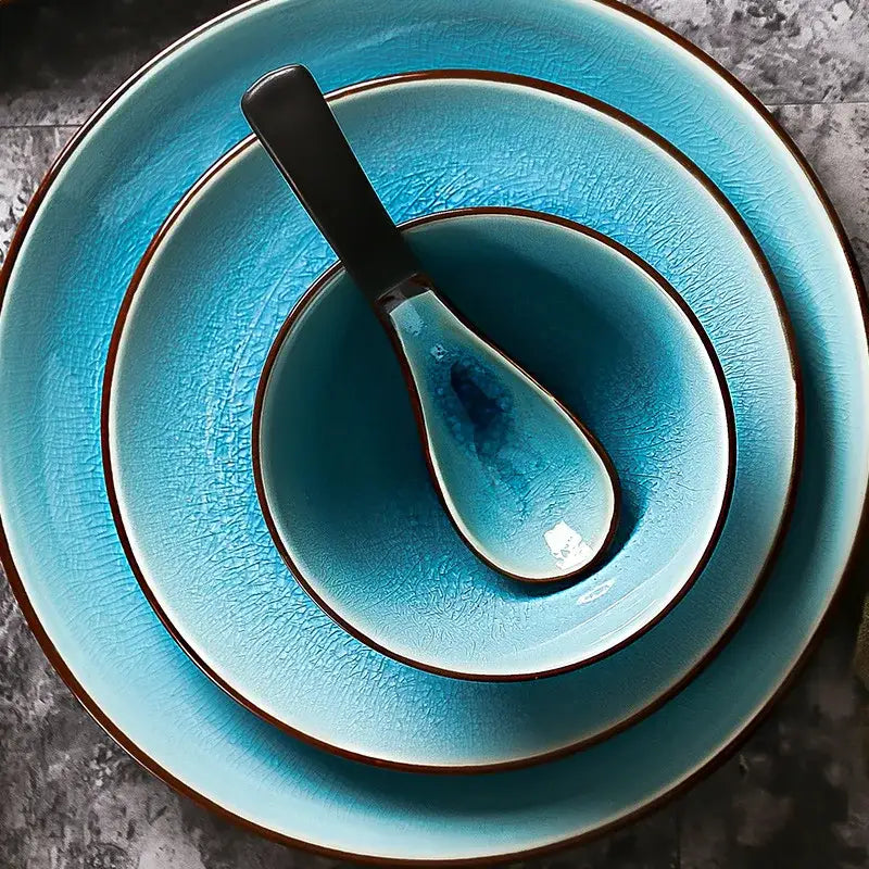 Set of three turquoise ceramic tableware pieces with ice cracking glaze and dark brown rims plus matching spoon