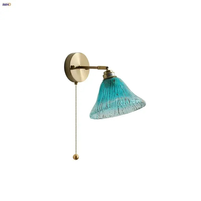 Turquoise textured blue glass wall sconce with brass fixture and pull chain for staircase decorbites blue glass lighting