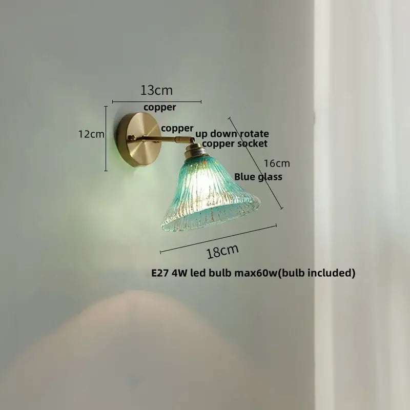 Vintage-style wall sconce with copper finish and decorbites blue glass shade designed for staircase lighting