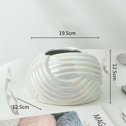 A sleek iridescent white ceramic desktop storage vase with swirling ribbed design for decorbites ceramic desktop use