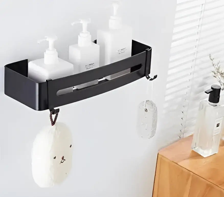 Two tier black aluminum corner shelf bathroom caddy by decorbites holds three white pump bottles with hooks