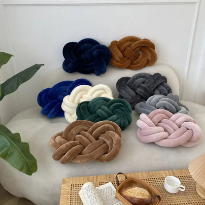 A collection of velvet knot throw pillows in navy blue brown white green gray and pink for living room decor