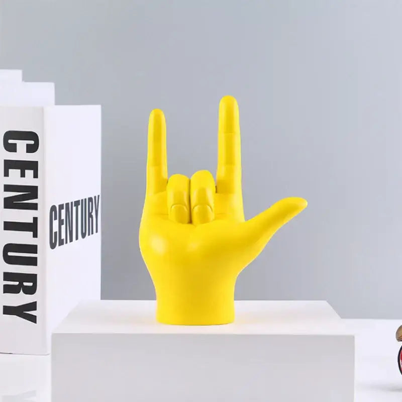 Vibrant yellow resin decorbites abstract hand love sculpture featuring rock gesture for living room decor