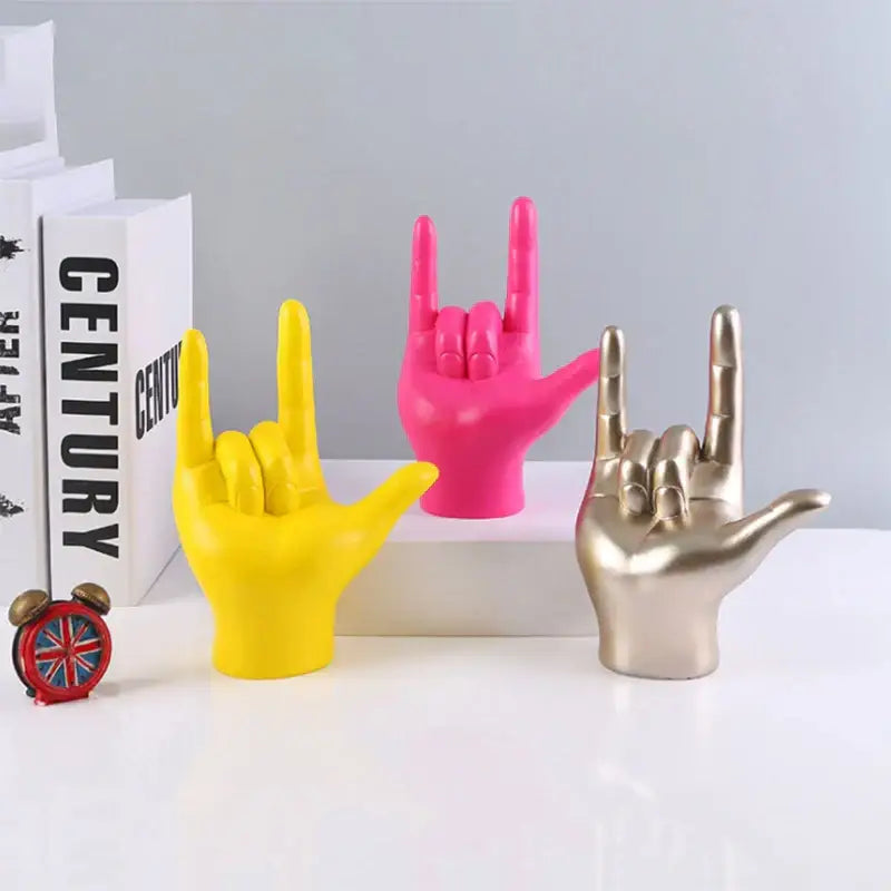 Vibrant decorbites abstract hand love sculpture in yellow pink and gold resin with rock gesture for living room decor