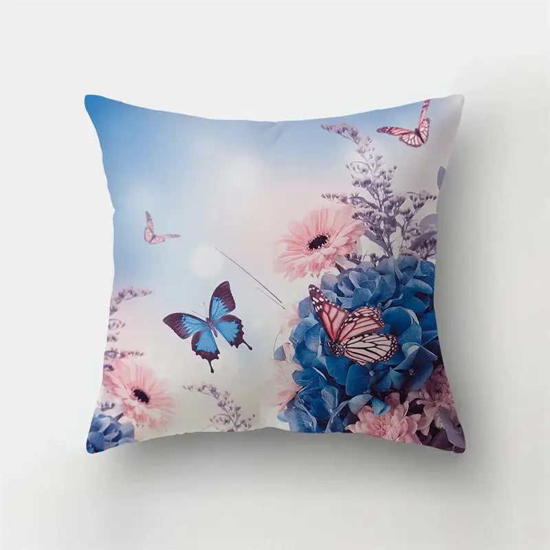 A vibrant decorbites butterfly flower pillow with blue and pink flowers and butterflies on a soft sky backdrop for living room decor