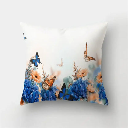 White throw pillow case with vibrant blue hydrangeas, orange monarch butterflies, and peach flowers for decorbites butterfly flower decor