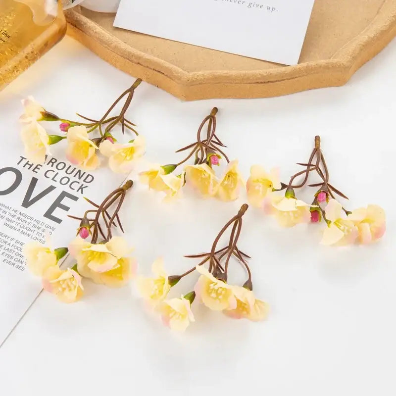 Delicate decorbites artificial flowers with pale yellow petals and pink buds on brown stems for living room decor