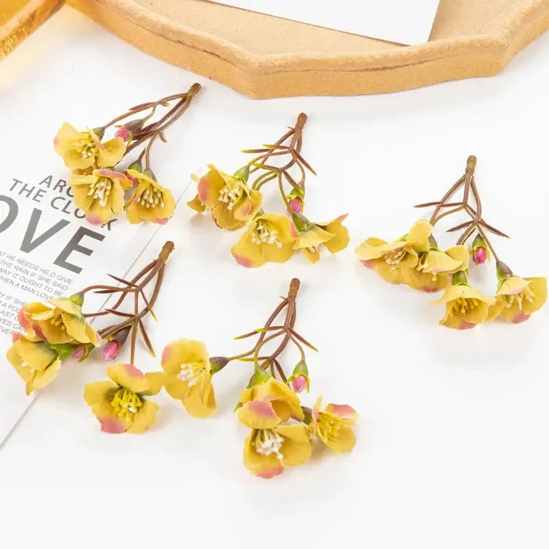 Vibrant yellow artificial flowers with pink tipped petals and brown stems for living room decorbites artificial decor