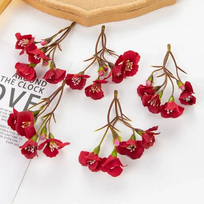 Vibrant red artificial cherry blossom flowers with delicate petals and brown stems for living room decor by decorbites artificial flowers