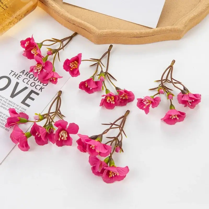 Vibrant pink artificial cherry blossom branches with delicate petals and brown stems by decorbites artificial flowers for living room decor