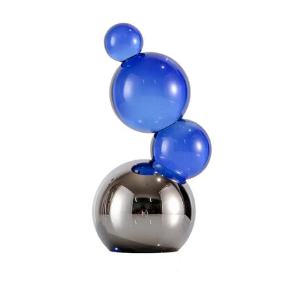 Vibrant glossy blue crystal bubble decor spheres stacked on a reflective silver base for elegant home decor