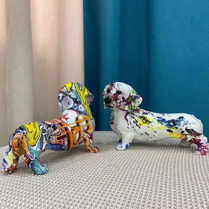 Two vibrant graffiti art dachshund dog resin figurines with colorful paint splatters for living room decor by decorbites