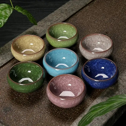 Set of seven vibrant ice cracking ceramic tea cups in green blue and pink hues perfect for dining room decorbites decor