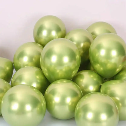 A pile of shiny metallic sage green latex confetti balloons with a pearlescent finish for party decor