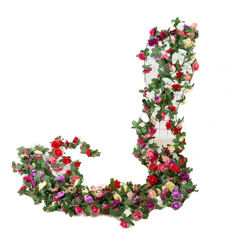 A vibrant multi-colored rose flowers vine garland with pink red purple and white blooms for living room decor