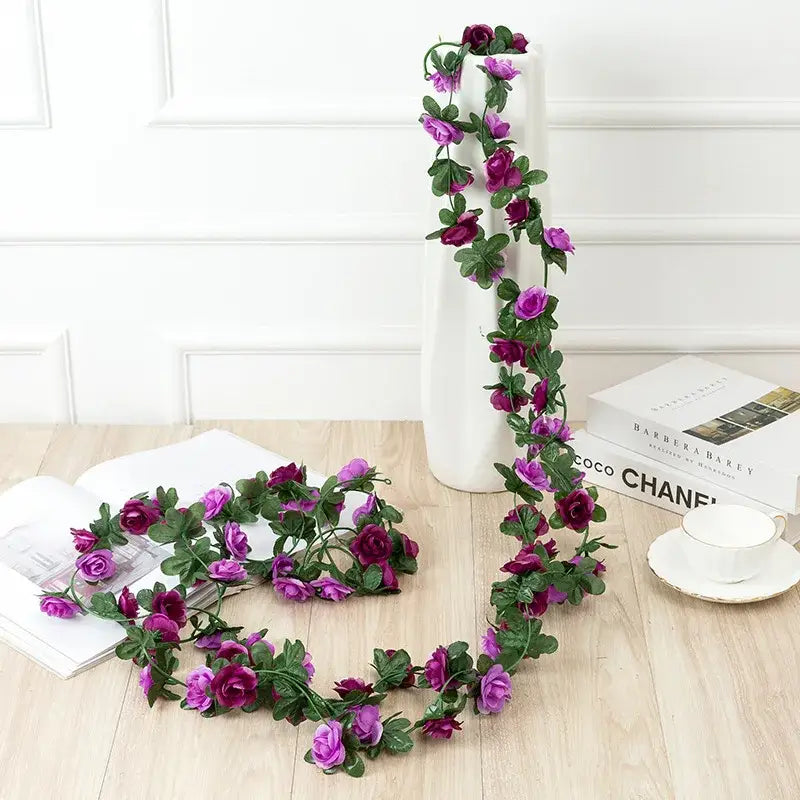 Purple and deep magenta synthetic rose flowers vine garland with green leaves for vibrant living room decor