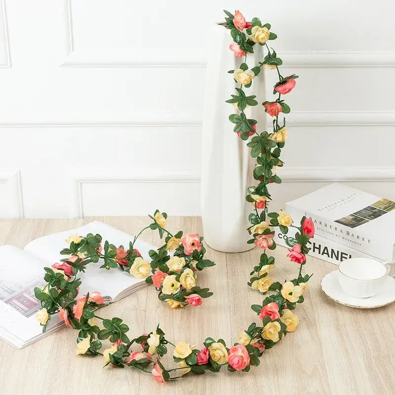 Delicate artificial rose flowers vine garland with soft pink and yellow roses and lush green leaves for living room decor