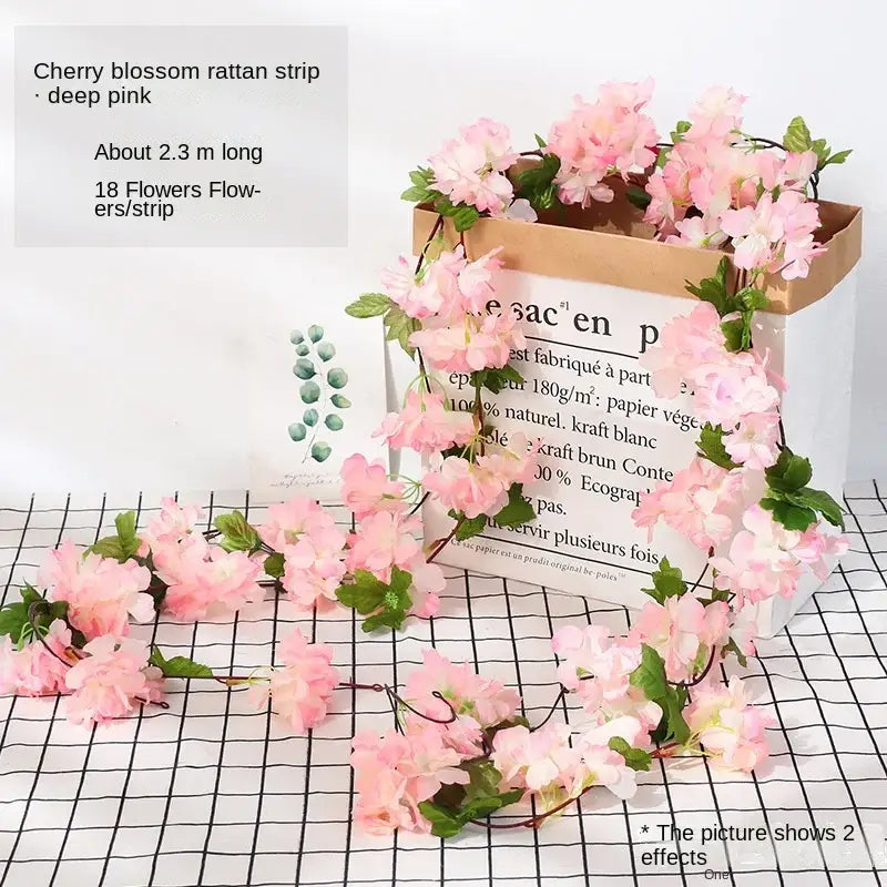 Pink cherry blossom floral garland made of rattan with green leaves in vibrant rose flowers vine garland decor