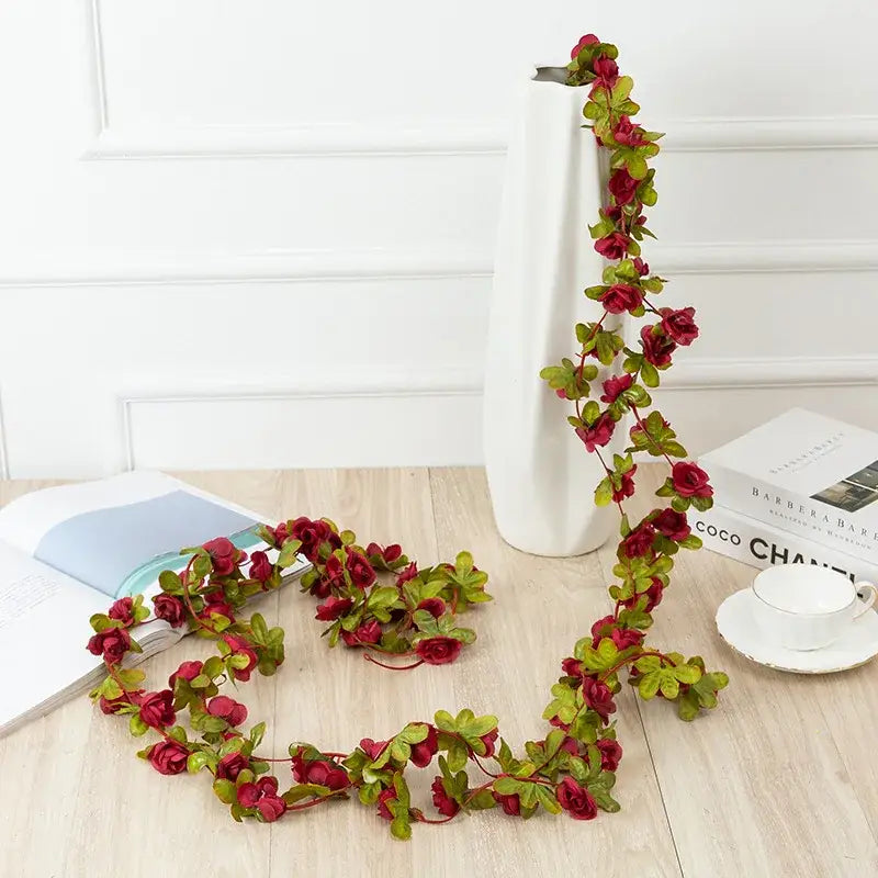 Decorative artificial rose flowers vine garland with deep red blooms and green leaves for living room decor